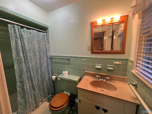 bathroom with vanity, a textured ceiling, decorative backsplash, and tile walls