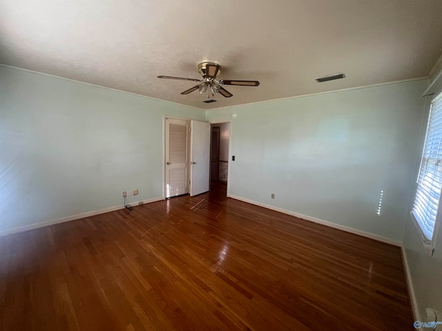 spare room with ornamental molding, ceiling fan, and dark hardwood / wood-style floors