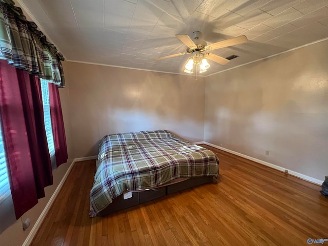 unfurnished bedroom featuring ceiling fan, hardwood / wood-style flooring, and ornamental molding