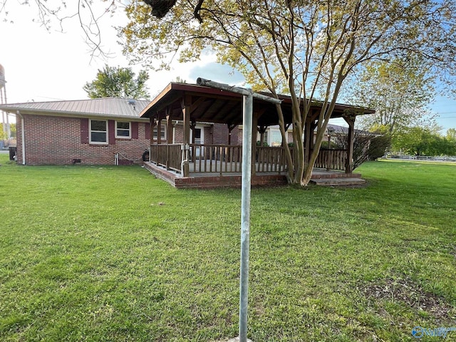 rear view of house featuring a lawn