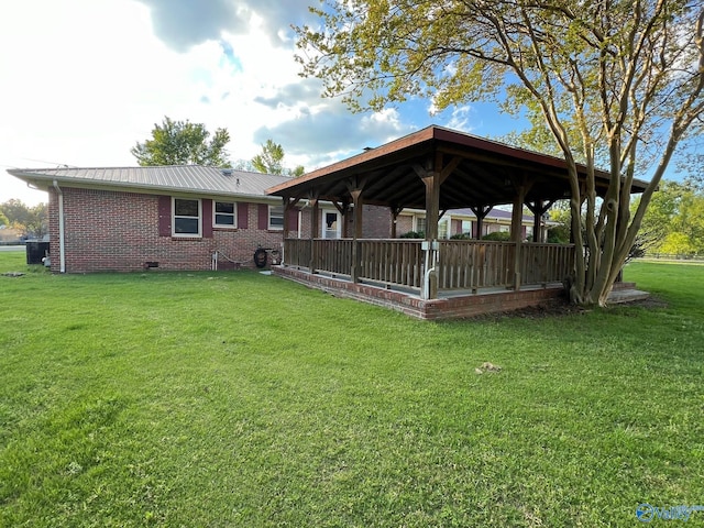 back of house with a gazebo and a yard