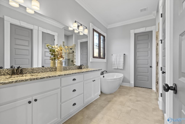 bathroom with a tub, vanity, and ornamental molding