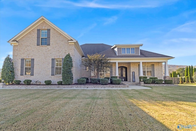 front of property with covered porch and a front lawn