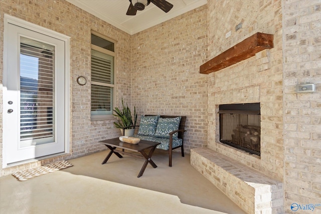 view of patio with an outdoor brick fireplace and ceiling fan