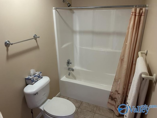 bathroom with toilet, tile patterned flooring, and shower / tub combo