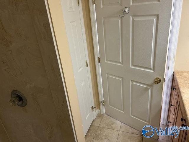 bathroom with tile patterned floors and vanity