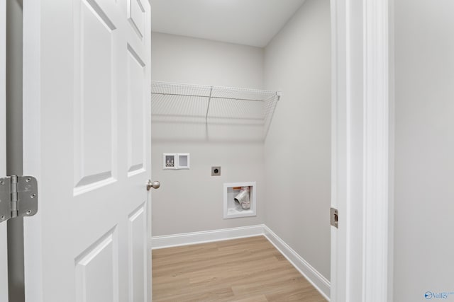 laundry room featuring washer hookup, light hardwood / wood-style floors, and electric dryer hookup