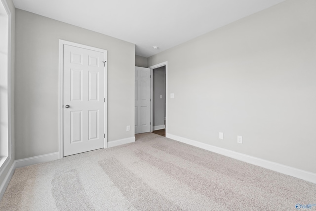 unfurnished bedroom with light carpet