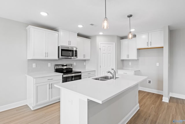 kitchen featuring white cabinetry, appliances with stainless steel finishes, and sink