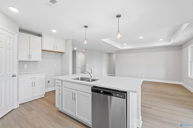 kitchen featuring dishwasher, a kitchen island with sink, sink, and white cabinets