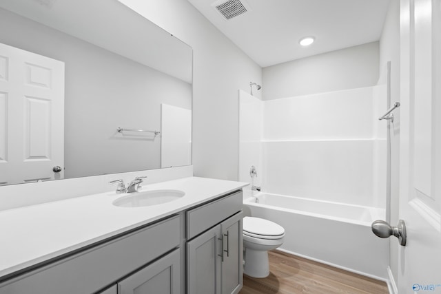 full bathroom with vanity, hardwood / wood-style floors, toilet, and shower / bath combination