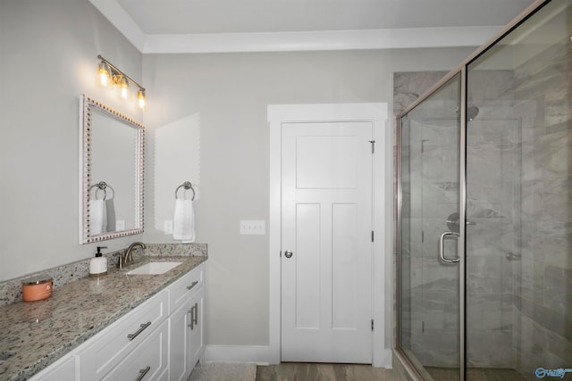 bathroom featuring vanity and a shower with shower door