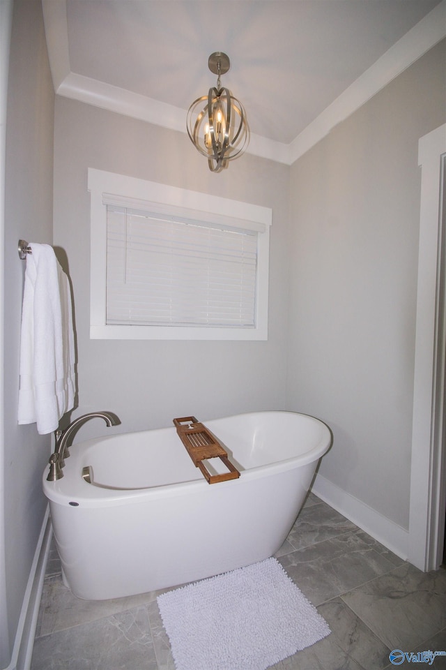 bathroom with an inviting chandelier and a tub to relax in