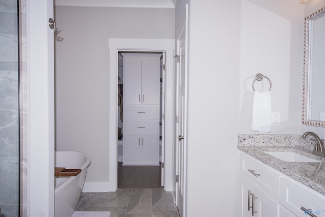 bathroom with vanity and a tub to relax in