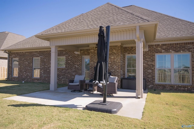 rear view of property featuring a yard and a patio area