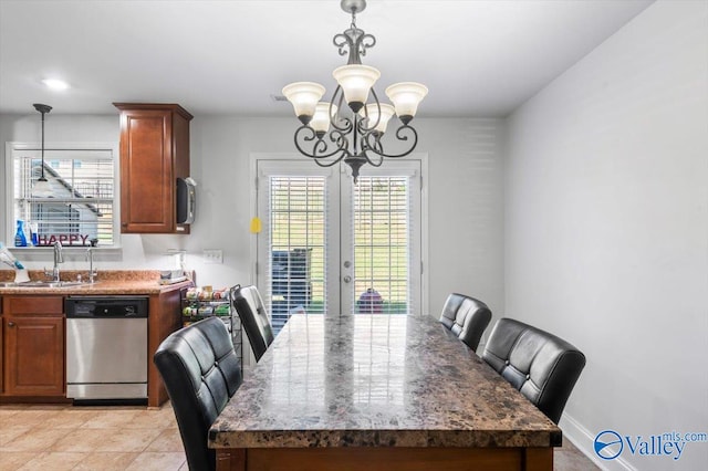 dining space with french doors, a chandelier, and sink