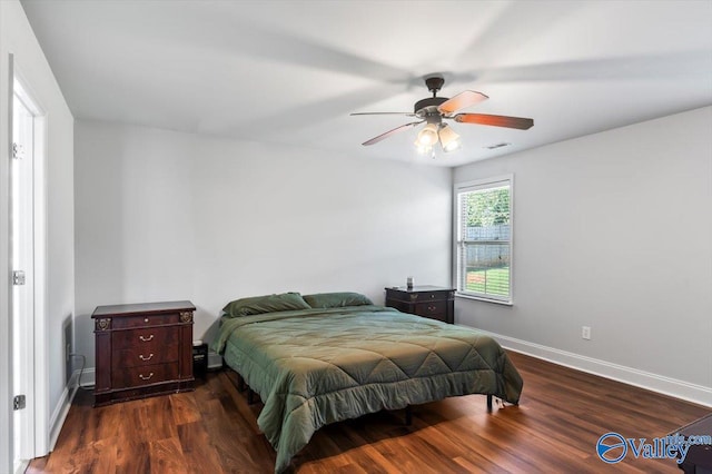 bedroom with dark hardwood / wood-style floors and ceiling fan