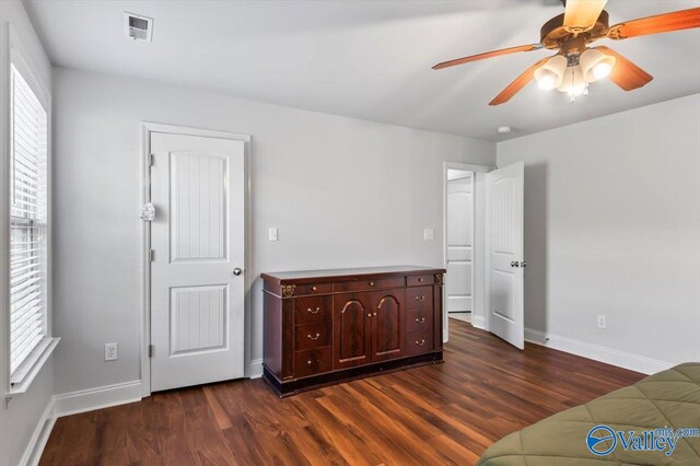 interior space with dark wood-type flooring and ceiling fan