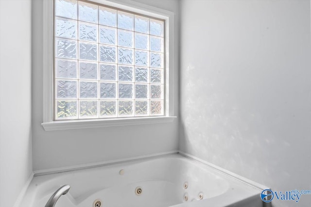 bathroom with a tub to relax in