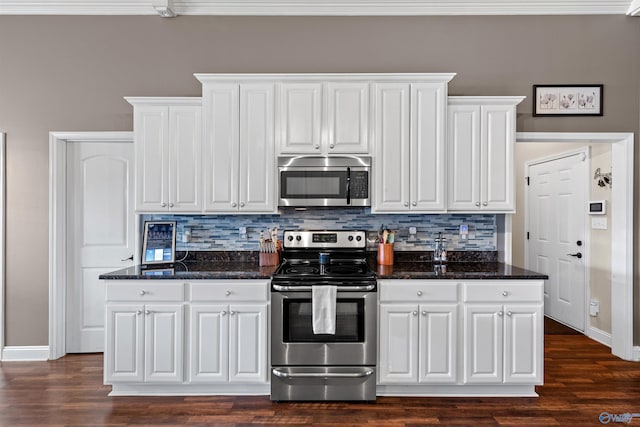 kitchen featuring decorative backsplash, appliances with stainless steel finishes, white cabinets, and dark wood finished floors