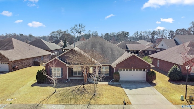 view of front of house with brick siding, driveway, an attached garage, and a front yard