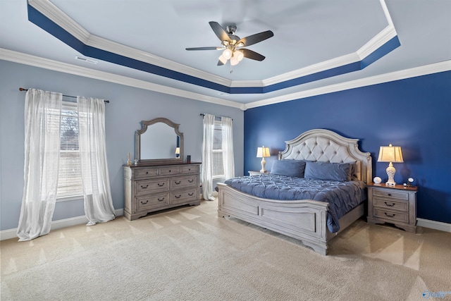 bedroom featuring visible vents, crown molding, baseboards, a tray ceiling, and carpet floors