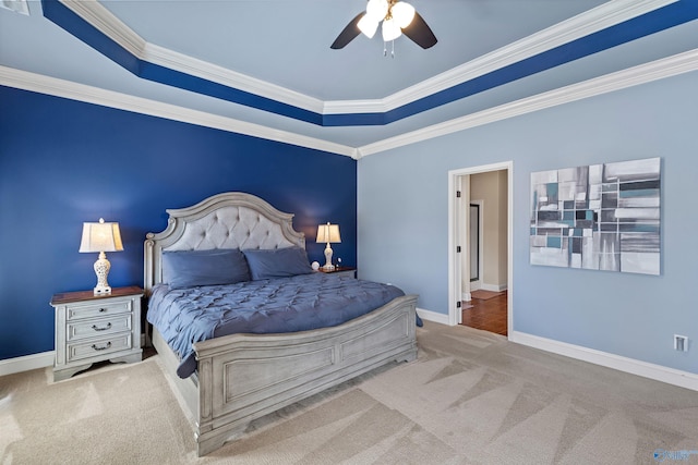 carpeted bedroom with ceiling fan, crown molding, and baseboards