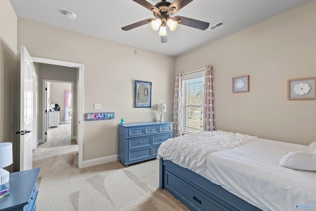 bedroom featuring visible vents, light colored carpet, baseboards, and ceiling fan