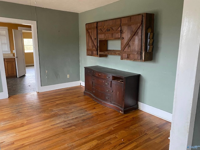 interior space featuring dark wood-type flooring and baseboards