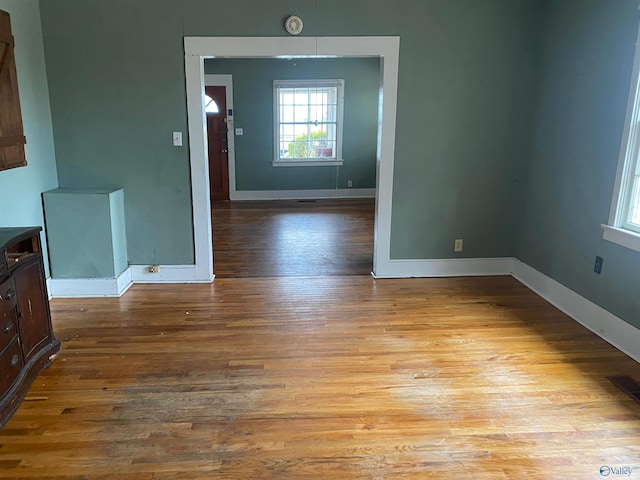 interior space featuring light wood-style flooring, visible vents, and baseboards