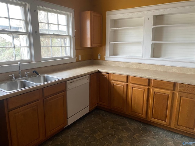 kitchen featuring light countertops, white dishwasher, a sink, and brown cabinets