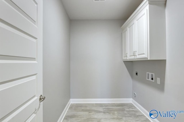 HUNTINGTONB Newby Chapel Rd, Athens, AL 35613 - laundry area with hookup for an electric dryer, baseboards, cabinet space, and hookup for a washing machine