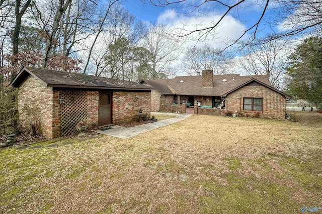 back of house with a lawn