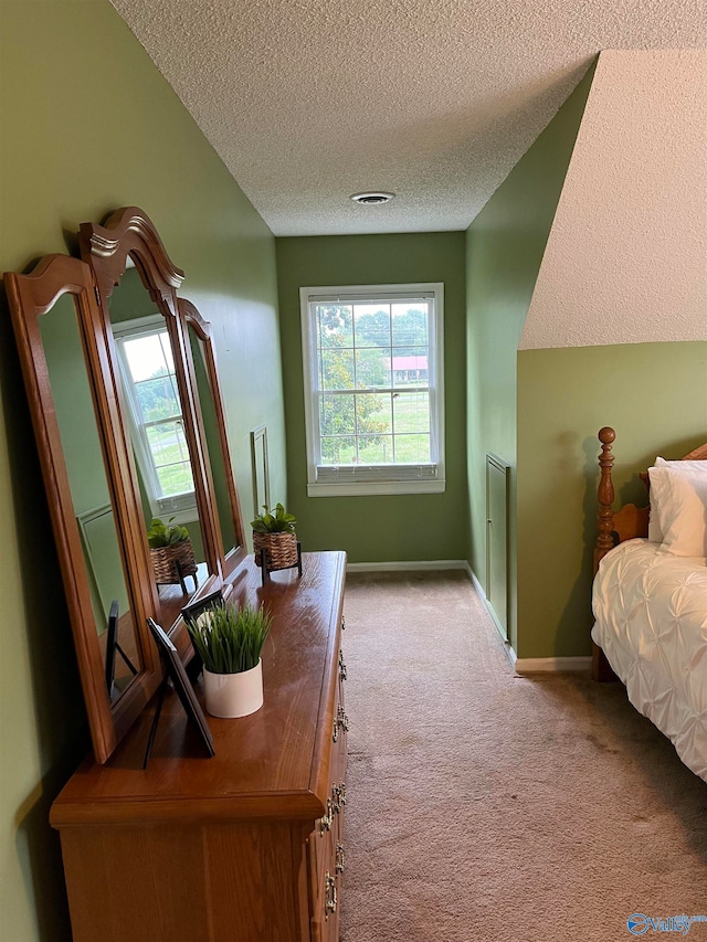 bedroom featuring a textured ceiling and carpet