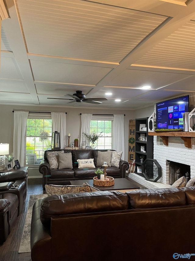 living room with ceiling fan, dark wood-type flooring, coffered ceiling, and a brick fireplace