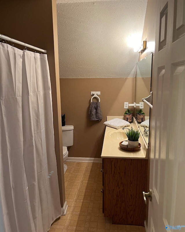 bathroom with a textured ceiling, toilet, tile patterned floors, vanity, and vaulted ceiling