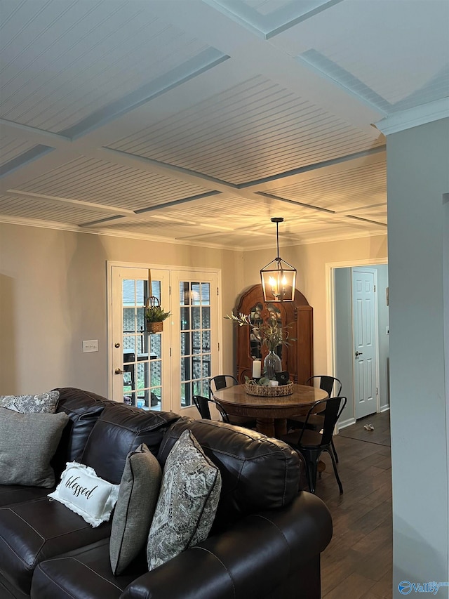 living room featuring a notable chandelier, dark wood-type flooring, and french doors