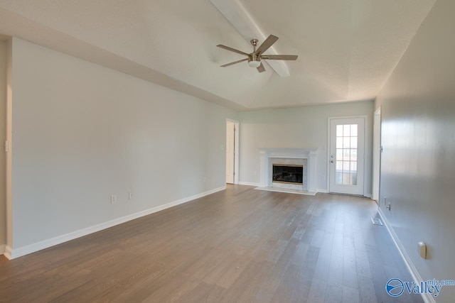 unfurnished living room with wood-type flooring, ceiling fan, and a premium fireplace