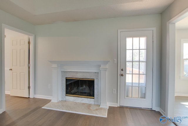 unfurnished living room featuring hardwood / wood-style flooring and a fireplace