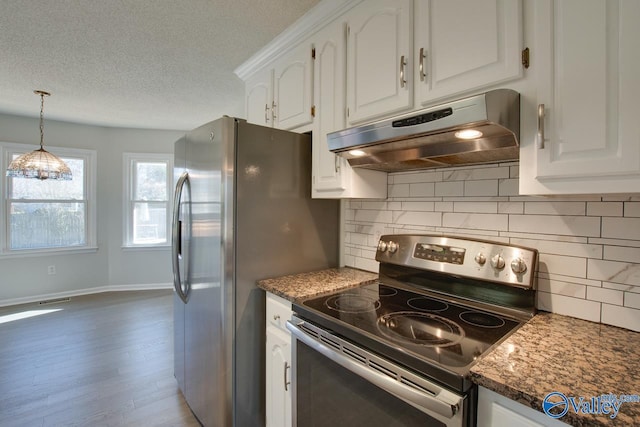 kitchen featuring white cabinets, dark hardwood / wood-style floors, dark stone countertops, and appliances with stainless steel finishes