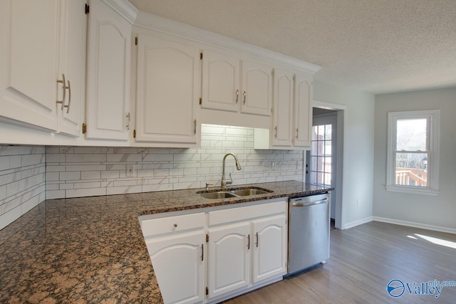 kitchen featuring white cabinets, light wood-type flooring, stainless steel dishwasher, and sink