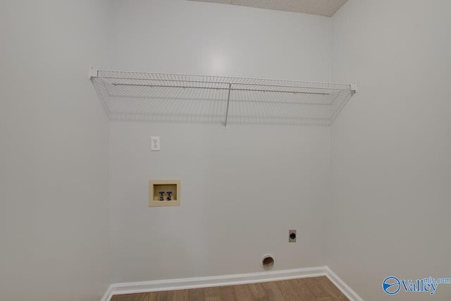 laundry room with hookup for a washing machine, hardwood / wood-style flooring, and electric dryer hookup