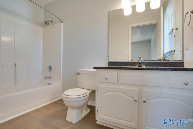 full bathroom with hardwood / wood-style flooring, vanity, toilet, and bathing tub / shower combination