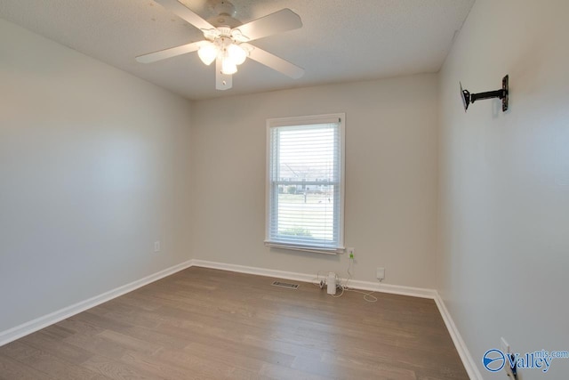 spare room featuring ceiling fan, a textured ceiling, and light hardwood / wood-style flooring