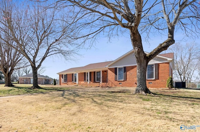 single story home featuring brick siding and a front lawn