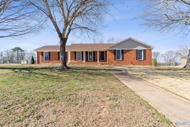 ranch-style home with a front lawn and brick siding