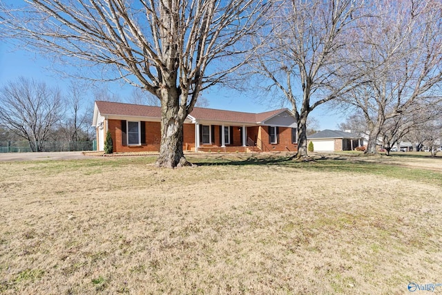 single story home featuring brick siding, covered porch, and a front lawn