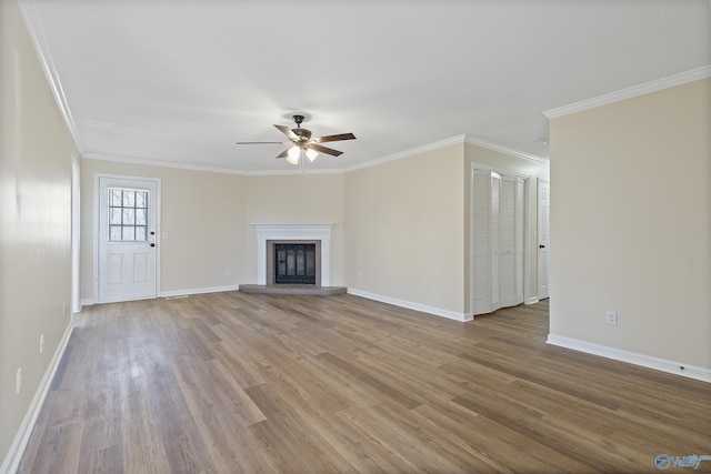 unfurnished living room with wood finished floors, a ceiling fan, and baseboards