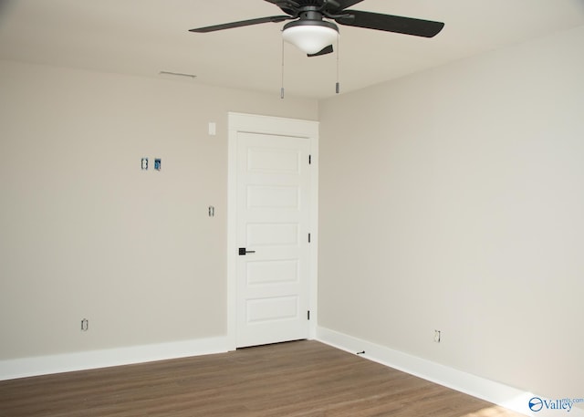 spare room featuring ceiling fan and dark wood-type flooring