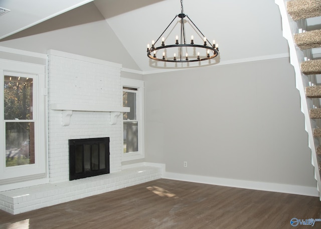 unfurnished living room featuring dark hardwood / wood-style flooring, lofted ceiling, and a brick fireplace